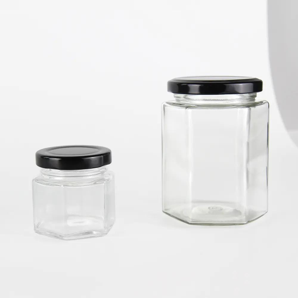 Vente chaude pot en verre pot de miel alimentaire petit pot emballage conteneur hexagonal avec couvercle à vis en métal