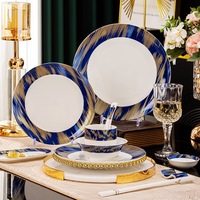 Service de vaisselle moderne et minimaliste en céramique haut de gamme de Jingdezhen avec incrustations dorées, comprenant bols, sous-plats et assiettes, spécial pour hôtels, restaurants et cadeaux, vente en gros