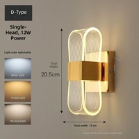 Lampe murale LED en fer et acrylique au design moderne avec abat-jour noir/doré, idéale pour l'éclairage décoratif de chambre à coucher