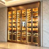 Cave à vin haut de gamme dorée à trois portes avec éclairage LED intérieur pour une présentation parfaite des bouteilles