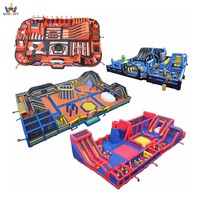 Parc de jeux gonflable massif avec parcours d'obstacles, toboggan, mur d'escalade, labyrinthe, jeu de boule de démolition, terrain de jeu pour la location, team building