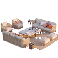 Ensemble de salon de jardin en rotin créatif de designer nordique pour l'extérieur, idéal pour les maisons d'hôtes, hôtels en plein air, villas, complexes hôteliers et jardins, avec chaise et table basse