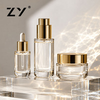 Faible QUANTITÉ MINIMALE DE COMMANDE Eco Friendly Durable Personnalisé Private Label Or Couronne de Luxe Unique Recyclable Verre Soins De La Peau Emballage Bouteille Ensemble