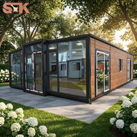 Cabine conteneur préfabriquée extensible, maison modulaire en acier, maison conteneur extensible moderne de luxe de 40 pieds avec mur entièrement vitré