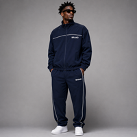 Fabricants de vêtements sur mesure : Survêtements oversize zippés, ensembles de survêtements en nylon avec impression sérigraphiée, coupe-vent à passepoil pour hommes