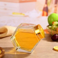 Penjualan Panas Stoples Madu Kaca Berbentuk Heksagon dengan Tutup Kayu dan Sendok Kayu untuk Pernikahan.