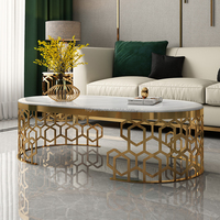 Table console moderne en acier inoxydable doré avec plateau en marbre et structure alvéolée pour salon