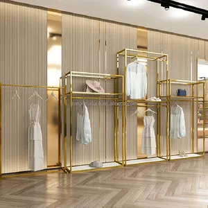 नई डिजाइन शानदार दीवार घुड़सवार चमकदार सोने स्टेनलेस स्टील कपड़ों की दुकान के लिए अनुकूलित लोगो कपड़े प्रदर्शन रैक