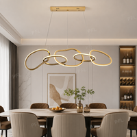 Lustre élégant et luxueux à boucles entrelacées ondulées, anneaux irréguliers dorés polis, suspension LED bicolore pour salon et bureau