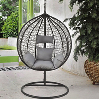 Fauteuil suspendu en forme d'œuf noir tissé, siège balançoire autoportant avec coussins