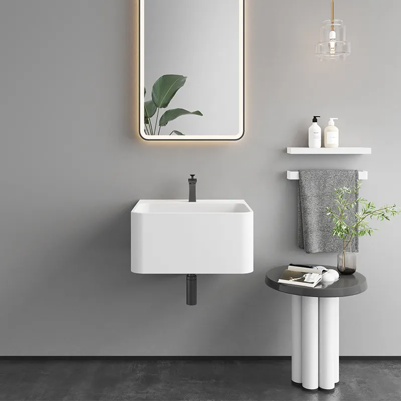 Lavabo de baño de resina de piedra artificial de superficie sólida de tamaño pequeño moderno al por mayor lavabo de tocador colgado en la pared para inodoro de apartamento