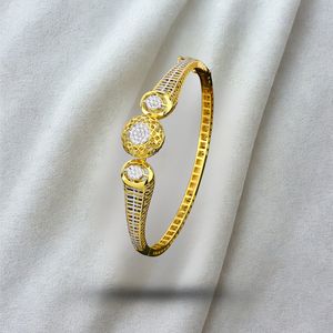 Gold Finish Elegant Bangle with Circular Stone Accent and Textured Detailing Modern Designer Jewelry for Women Special Occasion - Product Image 1