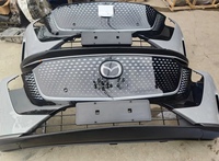 Bumper Depan Mobil Mazda EZ6 Original Bekas Terbongkar, Termasuk Grille, Sensor Radar, Kabel Harness, dan Perakitan Bumper Depan Asli.