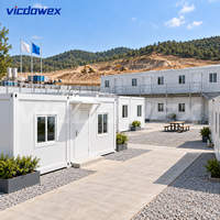 VICDOWEX Maison Conteneur Modulaire Préfabriquée Portable à Montage Rapide Design Contemporain pour Bureau de Chantier Éloigné et Dortoir