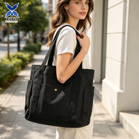 Sac fourre-tout en toile noire avec poche avant, rivets dorés, poche latérale et poignée en sangle assortie – Idéal pour le shopping, le travail quotidien et les voyages