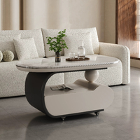 Table basse mobile incurvée en crème, surface en pierre microcristalline, base de rangement avec roulettes silencieuses, bureau minimaliste pour salon