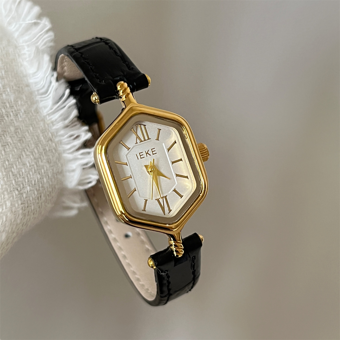 Black belt gold frame white surface