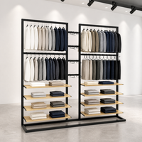 Étagère de présentation de vêtements en métal noir double face à deux niveaux avec étagères en bois et base en U – Vente en gros