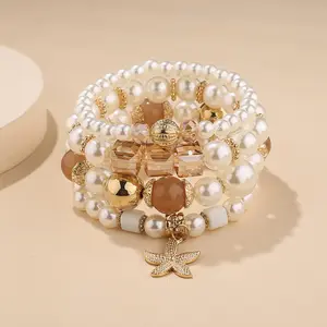 波西米亚风格珍珠串珠手链，带海星和树状图案 -- 弹性和金属设计
