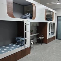 Lit superposé moderne multi-niveaux en forme de capsule, idéal pour les appartements étudiants, les hôtels-capsules et les auberges de jeunesse.