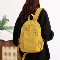 Sac à dos léger en nylon avec plusieurs poches zippées et compartiments latéraux élastiques, idéal pour l'école, les voyages ou le quotidien
