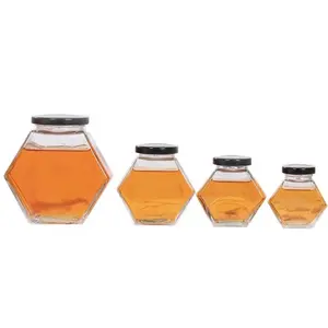 透明な六角形の食品グレードの空の透明なハニカム形状の金属蓋付き蜂蜜用ガラス瓶100ml