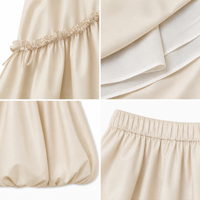 Jupe midi ballon beige pour femme, taille élastique, style estival, avec volants diagonaux, nœud décoratif, superposée et volumineuse, coupe trapèze, avec doublure