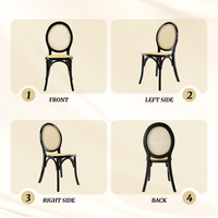 Chaise de banquet de mariage à dossier médaillon, cadre noir classique avec assise en rotin naturel pour la location d'événements hôteliers