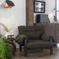 Fauteuil simple en velours vintage avec structure en bois massif et accoudoirs capitonnés pour salon, chambre ou salle de séjour