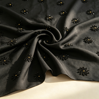Tissu TC noir A087 avec motif floral en spirale noir-doré pour robes de soirée et robes