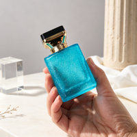 Flacon de parfum en verre texturé bleu 50 ml 1,7 oz avec bouchon noir et doré et col doré, logo personnalisé, OEM ODM, directement de l'usine