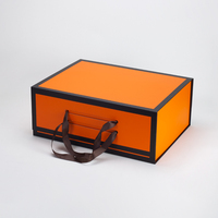 Boîte cadeau magnétique pliable de luxe avec design orange et noir et poignée