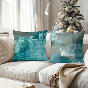 Абстрактные бирюзовые декоративные подушки украшают уютную гостиную, дополненные праздничными носочками и декором в виде оленьих рогов. - Product Image 4