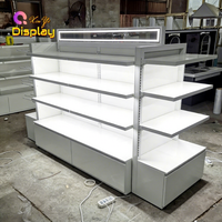 Comptoir de présentation de maquillage LED en acier inoxydable personnalisable XINYI, design robuste et écologique pour la présentation en magasin de cosmétiques