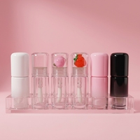 Tube de brillant à lèvres transparent avec applicateur tête de fruit mignon, flacons et emballages cosmétiques