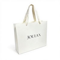 Sacs en papier blancs de qualité supérieure avec logo personnalisé, poignée en corde de coton, logo imprimé UV noir pour l'emballage de vêtements et de bougies
