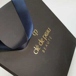 Custom Low Price <strong>Gold</strong> Foil Logo Elegant <strong>Black</strong> Luxury Clothing Shopping Paper <strong>Gift</strong> <strong>Bag</strong> With Ribbon Handle for Garment Packaging