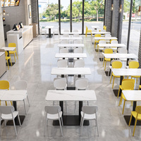 Table et chaises minimalistes pratiques, structure robuste, idéales pour les restaurants de restauration rapide, les cantines et les magasins d'alimentation