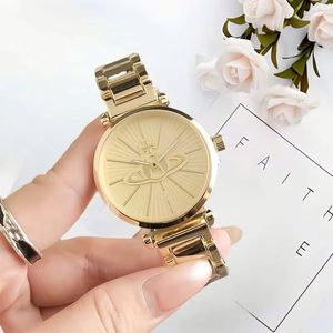 Nuevos relojes de pulsera de China con caja redonda dorada, diseño de Saturno, esfera con efecto rayos de sol, brazalete de metal, relojes de lujo para mujer. - Product Image 1