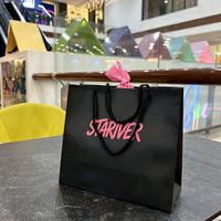 Sac de shopping en papier noir style chic avec logo personnalisé, nœud décoratif, sac d'emballage cadeau pour cosmétiques et bijoux