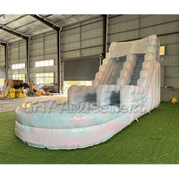 Grande structure gonflable rose avec toboggan aquatique et château sauteur à vendre
