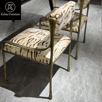 Fauteuil de salle à manger de luxe rembourré à rayures tigrées avec structure en métal bronze antique martelé pour salle à manger de villa