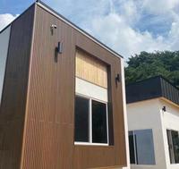 Panneau mural WPC imperméable et écologique pour la décoration de façade de maison, villa ou hôtel moderne et luxueux