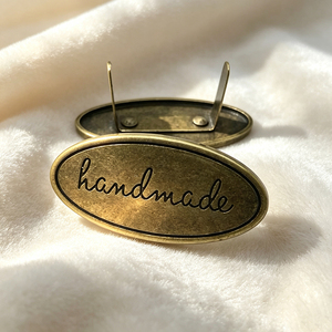 Custom Private Brand Metal <b>Name</b> <b>Labels</b> Own Logo Sew-on Metal Tags Customized Metal Emblems for Fashion Brand Apparel - Product Image 1