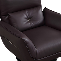Fauteuil de salon moderne en cuir écologique, pivotant, avec structure en fer moulé sur mesure et pieds en acier carbone.