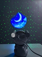 Projecteur d'étoiles LED populaire avec motif astronaute assis multicolore et haut-parleur Bluetooth