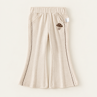 Pantalon évasé ivoire pour filles avec applique champignon, bordure de jambe en zigzag et poches latérales pour collections de vêtements pour enfants en gros et sur mesure