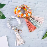 Amazon vendita calda moda personalizzata braccialetto di perline in Silicone portachiavi da polso con nappa in pelle