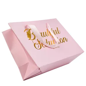 Vente en gros de sacs en papier à cadeaux roses de luxe avec logo imprimé personnalisé chaussures vêtements sacs à provisions