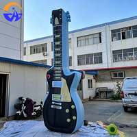 Guitare gonflable publicitaire personnalisée en tissu Oxford avec ventilateur intégré pour la décoration de scène de festival de musique
